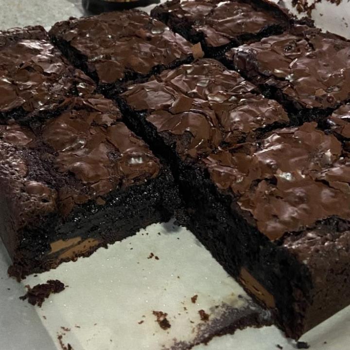 A tray of chocolate brownies with crackly tops, cut into squares